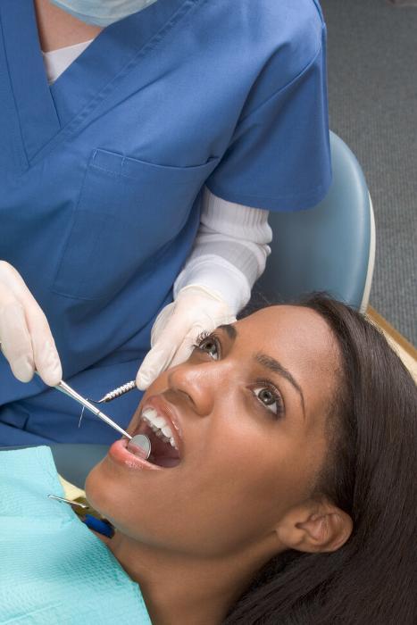 woman sitting in dental chair before tooth extraction