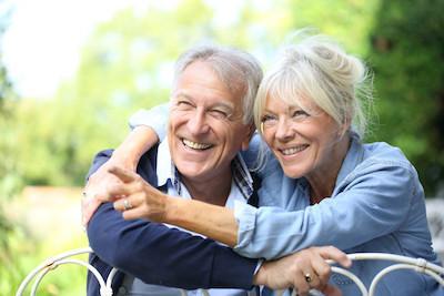 older man and woman smiling after dental implants