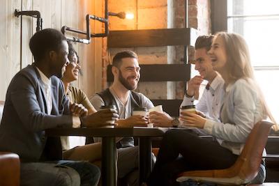 Group of friends talking at coffee house