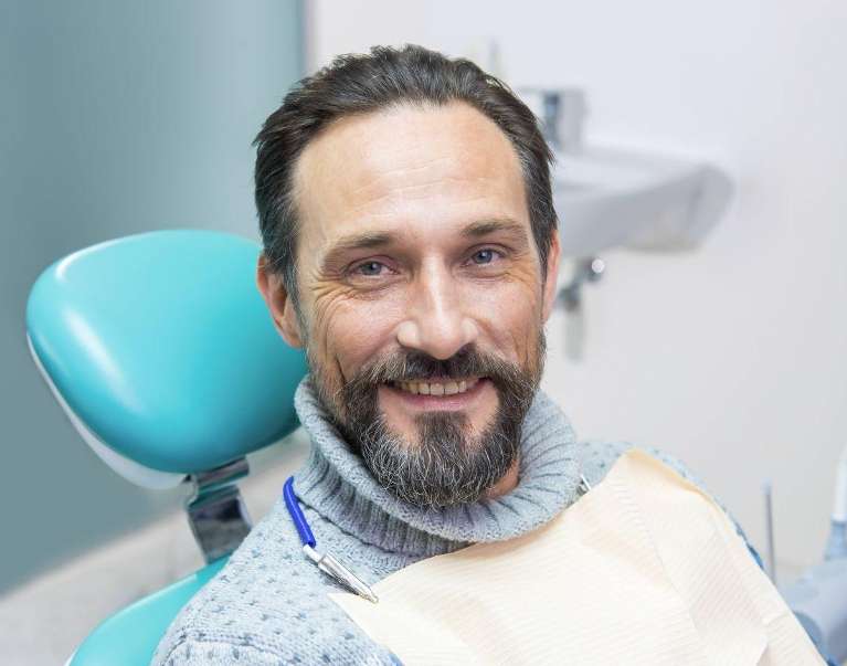 man sitting in a dental chair | Dentist in Palatine IL