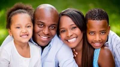family of four smiling 