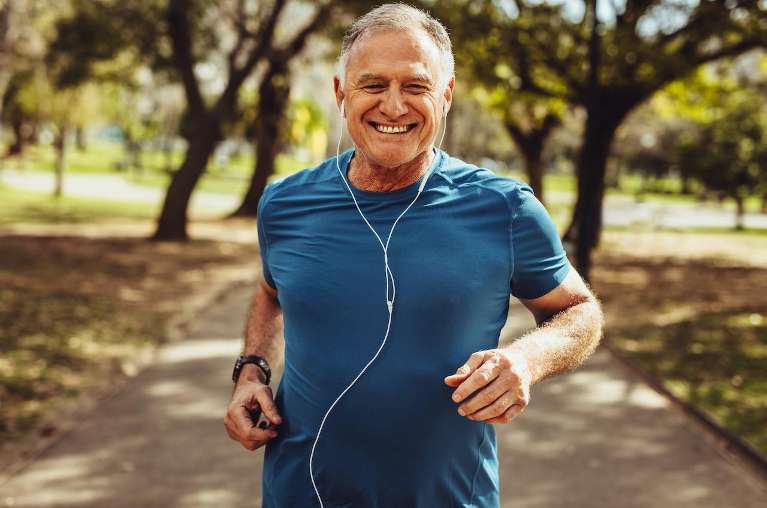 An older man jogging, showcasing vitality and dental health in Palatine.