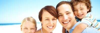 father, mother, daughter, and son smiling 