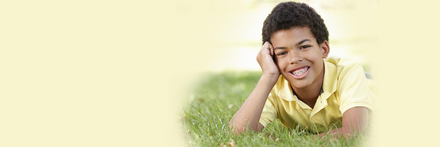young boy with braces smiling